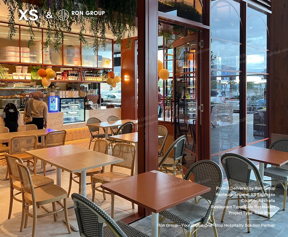 Cafe dining area with warm lighting greenery and display shelves