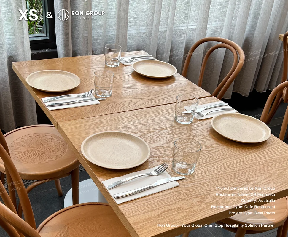 Wooden cafe table setting with chairs and tableware