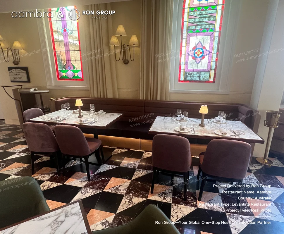Aambra dining area beneath stained glass windows