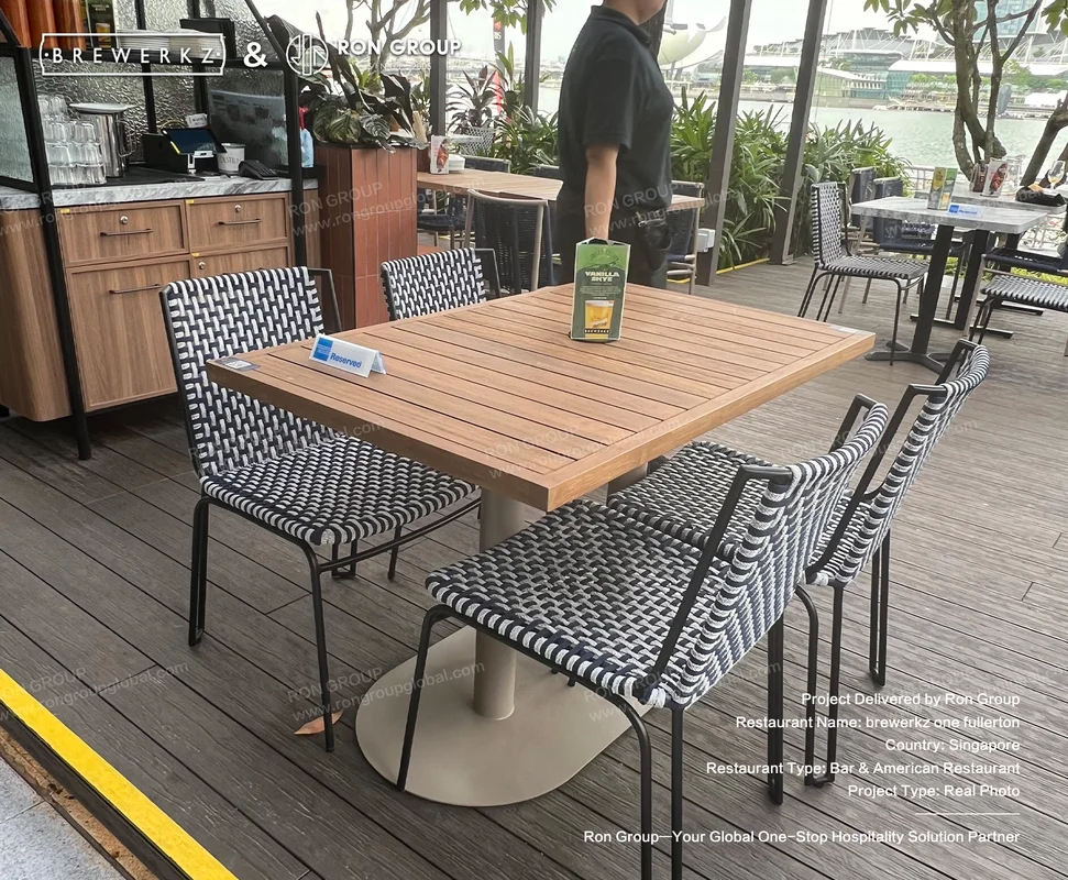 Brewerkz wooden table with woven chairs detail