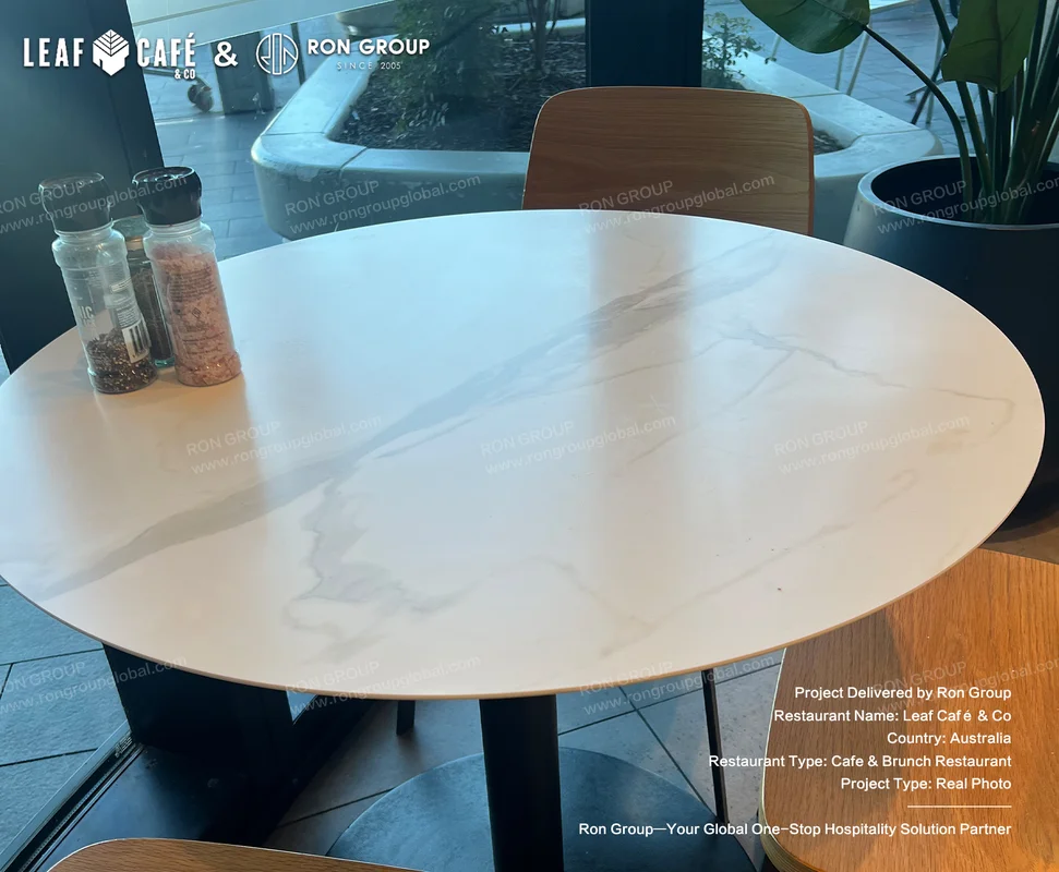 Leaf Café & Co round marble table by the window