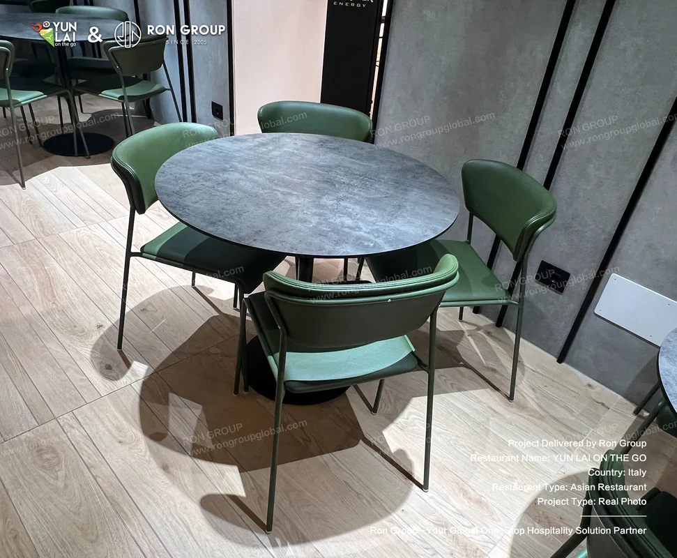 YUN LAI ON THE GO round tables and green chairs