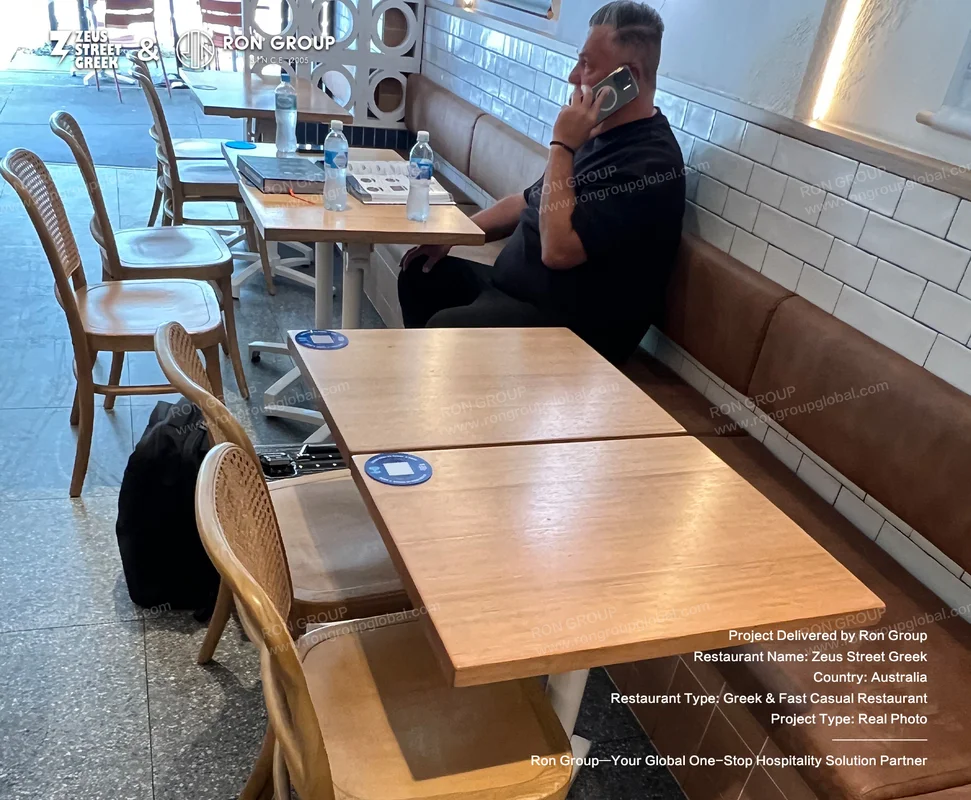 Zeus Street Greek dining room with wooden tables and leather booths