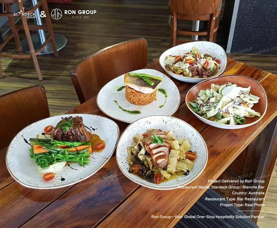 Blanche Bar RonGroup-Blanche_Bar-Plated_Gourmet_Dishes_On_Table.webp