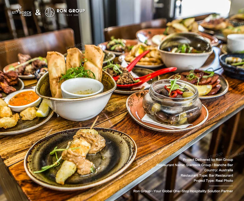 Blanche Bar RonGroup-Blanche_Bar-Wooden_Table_With_Dishes.webp