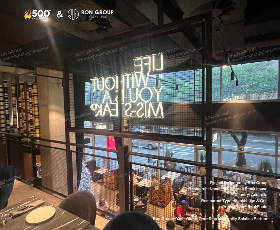 Neon signage and street-view dining at 500 Degrees Steakhouse
