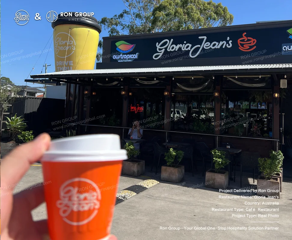 Gloria Jean's coffee in hand outside the cafe