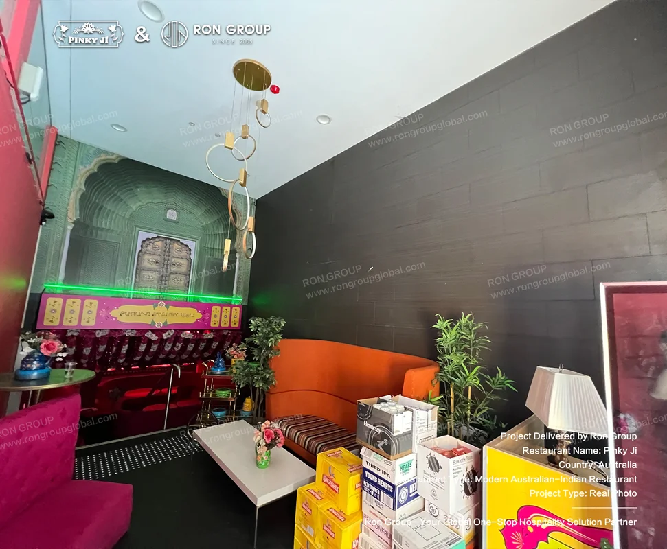 Pinky Ji colorful mural and orange sofa