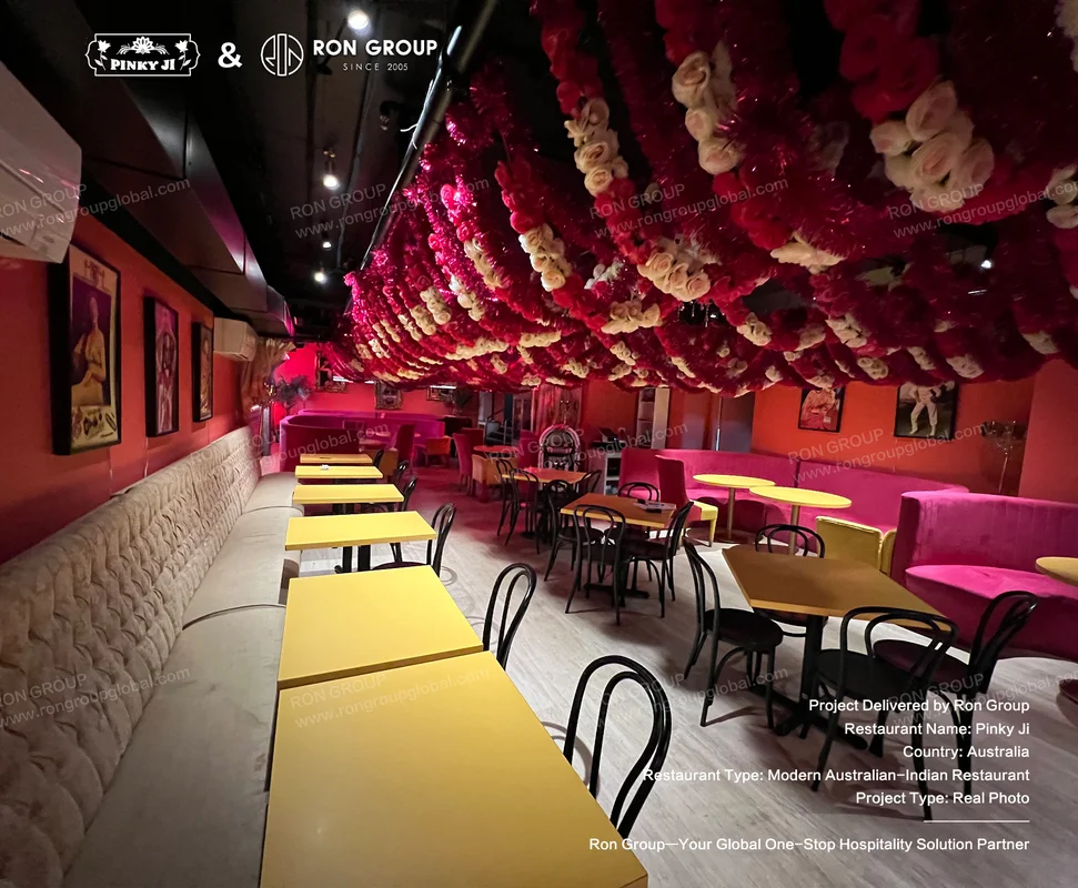 Pinky Ji vibrant floral ceiling and colorful seating