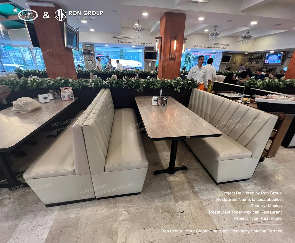 La Casa Abuelos RonGroup-A_Casa_Abuelos-Cream_Leather_Booths_And_Wooden_Tables.webp