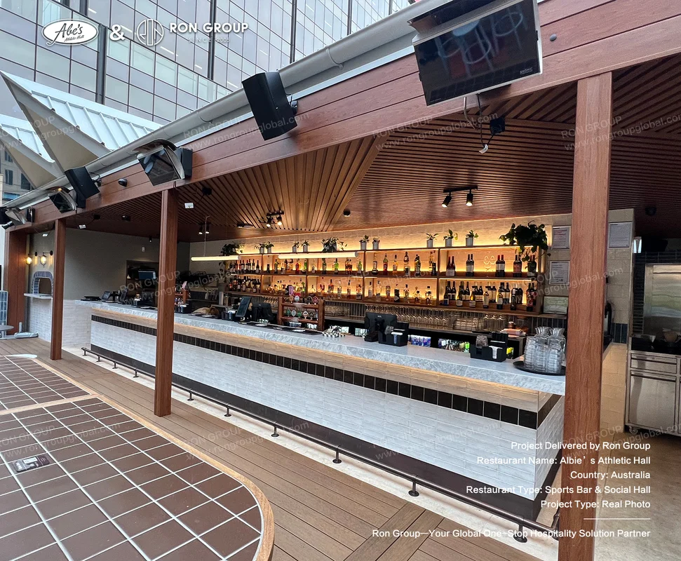 Covered outdoor bar with marble countertop black-and-white tile front and wooden ceiling beams