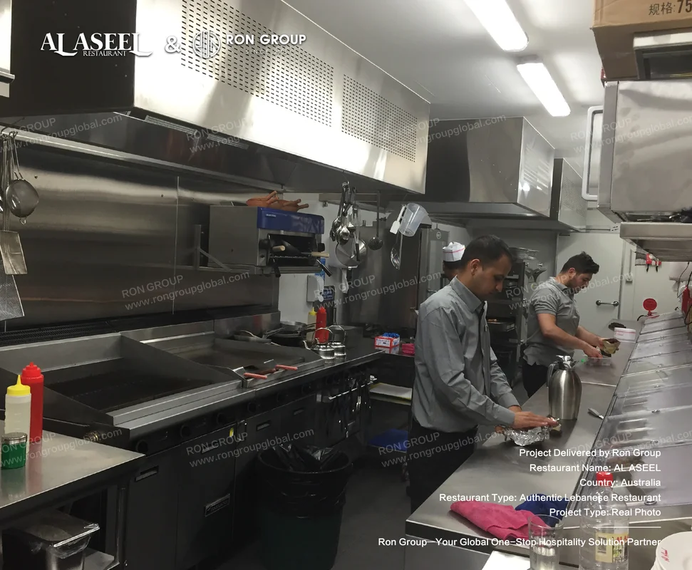 Al Aseel commercial stainless steel kitchen with exhaust hoods and prep counters