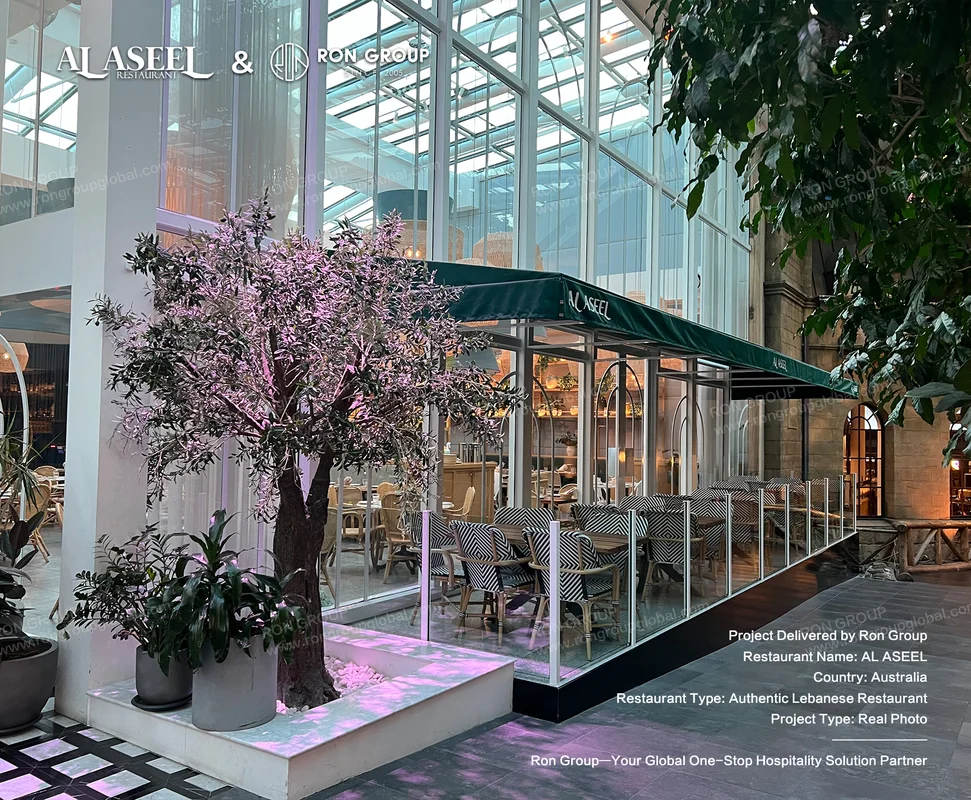 Al Aseel Sydney glass atrium exterior and monochrome woven terrace chairs