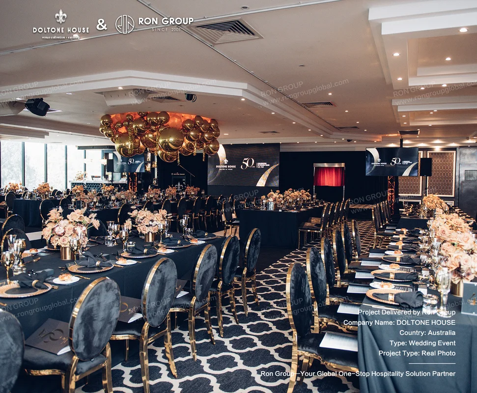 Luxury black and gold wedding banquet setup with gold-framed velvet chairs at Doltone House
