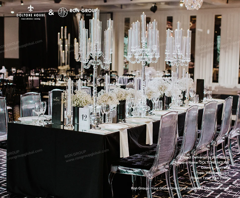 Doltone House black linen banquet tables with crystal candelabras and clear acrylic chairs