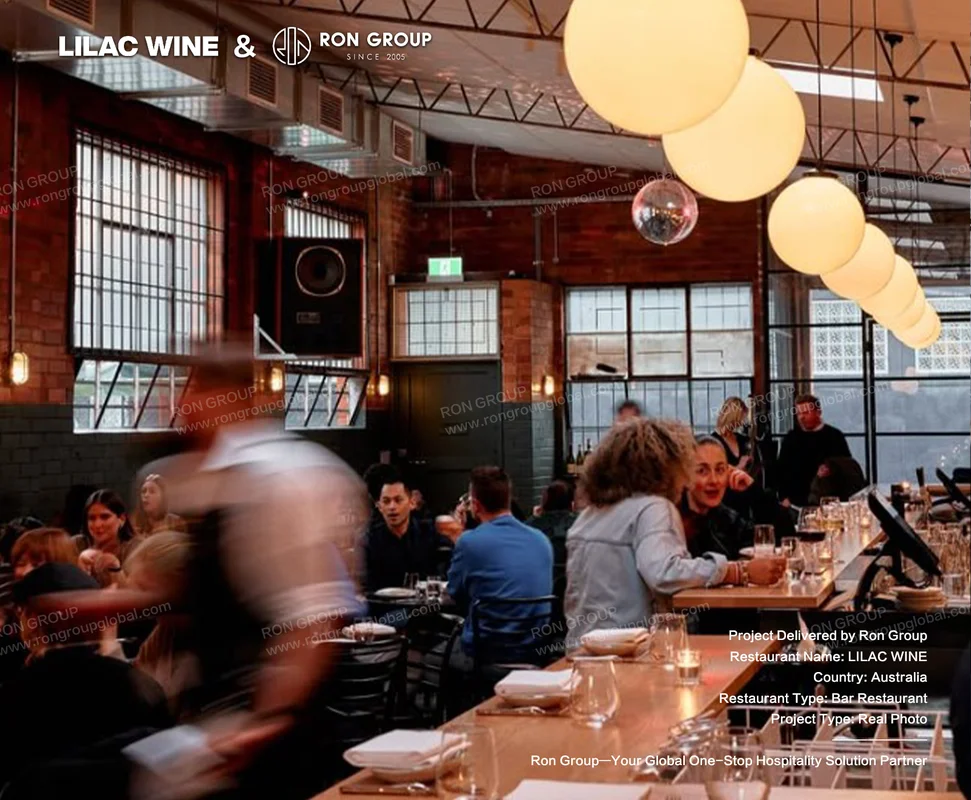 Bustling evening dining service at Lilac Wine with wooden bistro tables and brick walls