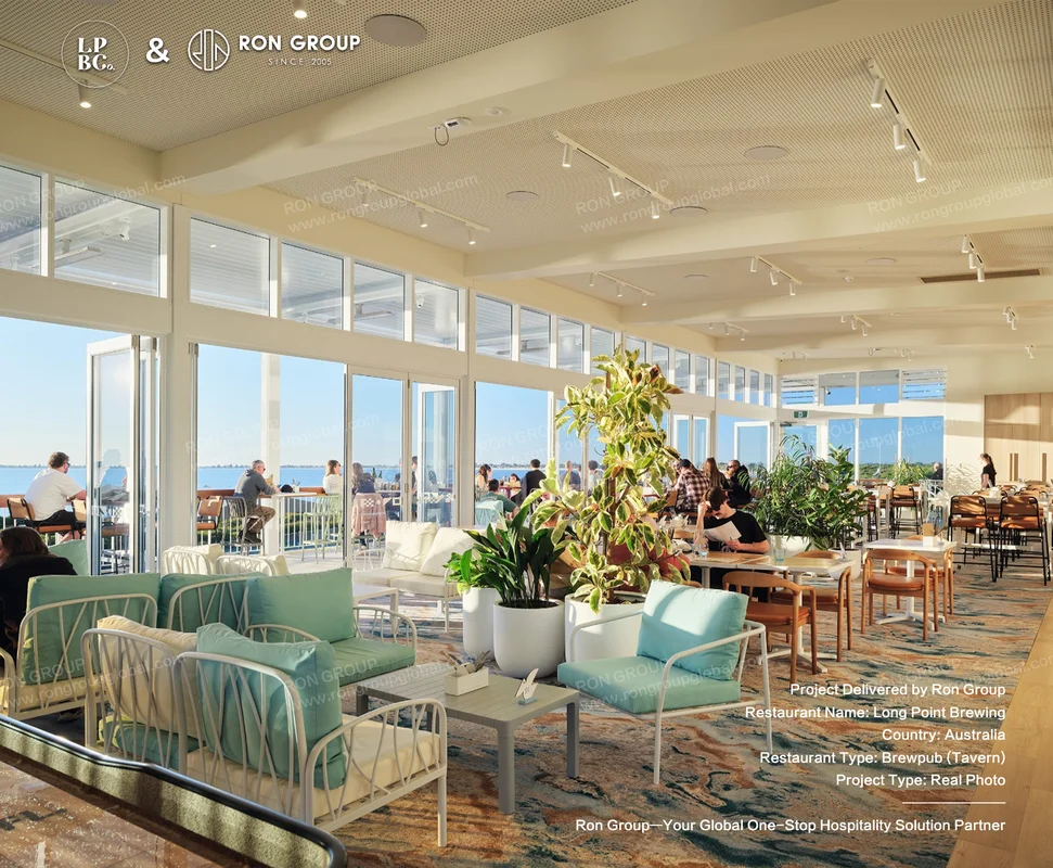 Sunlit waterfront dining room at Long Point Brewing with timber furniture and teal cushions
