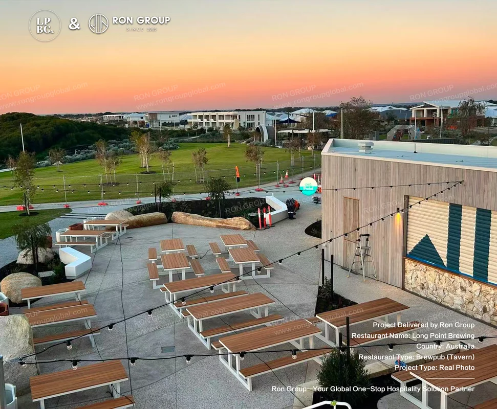 Long Point Brewing outdoor beer garden with wooden picnic tables and string lights at sunset