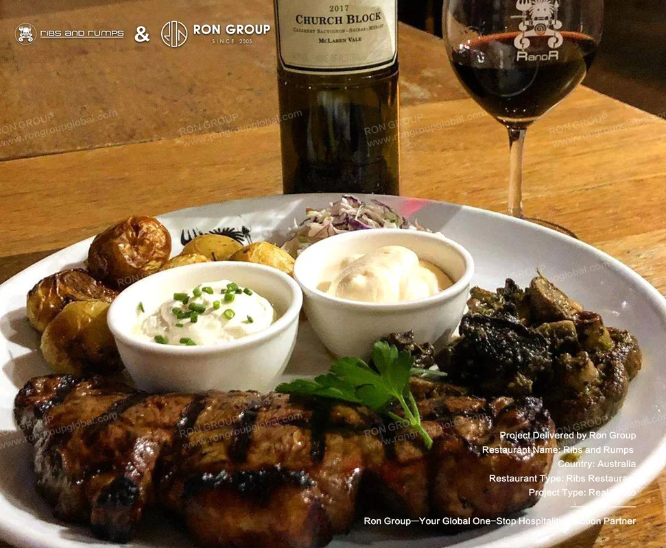 Signature glazed ribs with roasted potatoes and red wine service on solid wood table