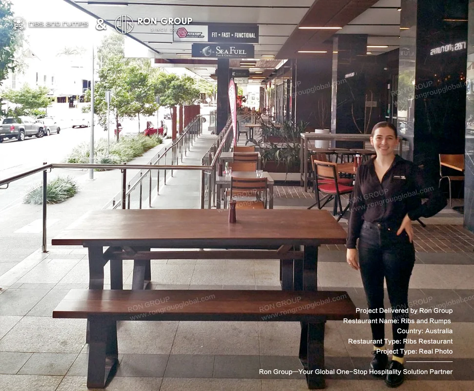 Sturdy picnic-style wooden table and integrated bench set on the covered outdoor terrace