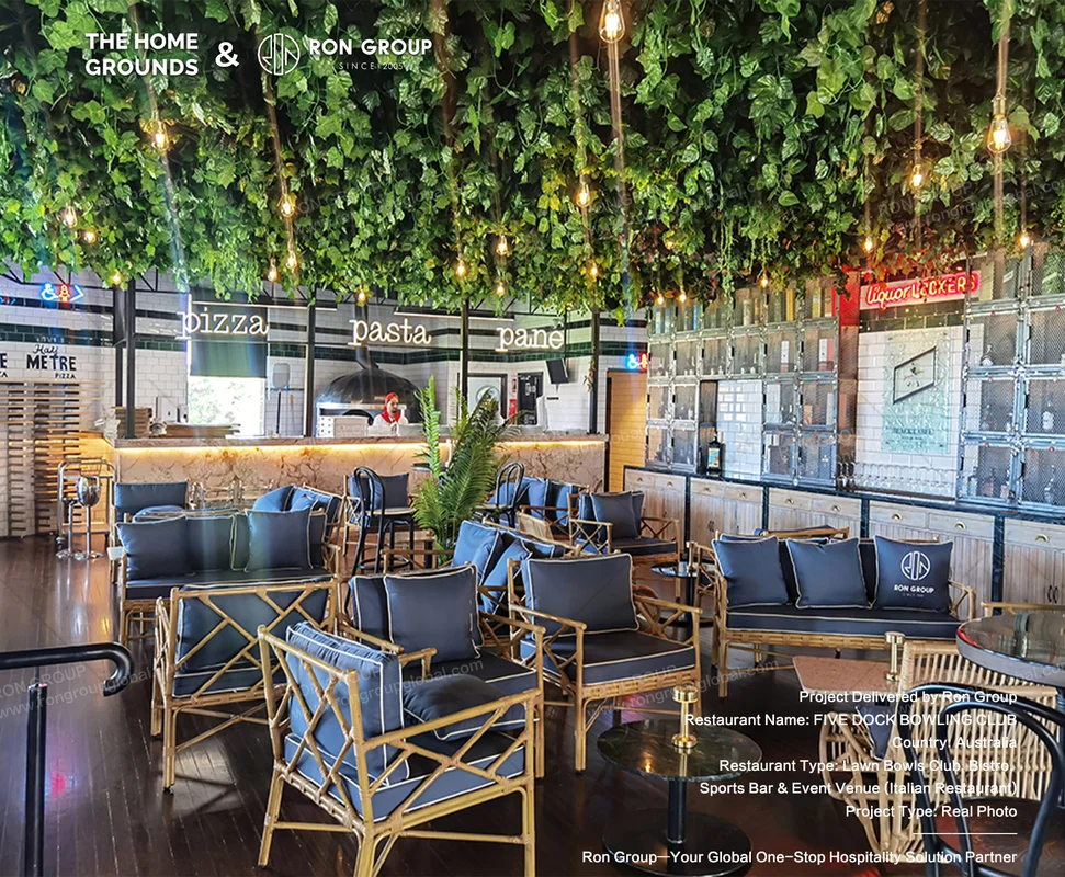 Botanical Italian dining zone with overhead greenery bamboo chairs and marble pizza counter