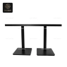 A rectangular table with a light-wood top and a black double-pedestal base.