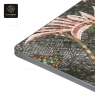 A close-up of a mosaic table top with a geometric pattern and dark metal edge.