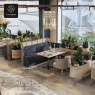 A dining space with a mix of booth and table seating, large windows, and numerous green plants.