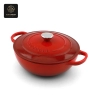 Another view of the vivid red, oval enamel cast iron dutch oven with its lid.
