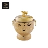 A golden induction cooker with ornate dragon carvings and a matching dragon head lid handle.