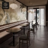 Dark brown stone table tops with a long, light-colored cushioned bench.