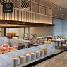 An overview of a modern dining area with a buffet line and several chafing dishes.