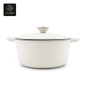 A white enamel cast iron dutch oven with its lid propped open.