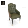 A dark green high-back armchair with patterned brown sides, on a white background.