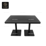 A rectangular table with a black top and a black double-pedestal base.