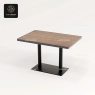 A Series E wood table top with a black double-column base on a white background.
