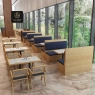 Restaurant interior with individual wood and navy upholstered booths and cane-back chairs.
