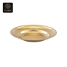 A single gold hammered service plate with an embossed texture on a white background.