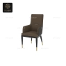 A high-back dining armchair with beige leatherette, dark legs and golden tips.
