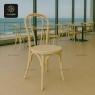 Light beige classic bentwood chair with a round seat in a cafe setting.