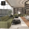 A spacious modern lounge with several dark green modular sofas and coffee tables.