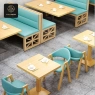 An elevated view of light-blue booth seating and wooden dining sets.