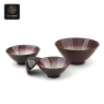A set of deep purple kiln-glazed bowls of various sizes, showcasing their unique effect and elegant shape.