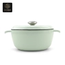 A light green enamel cast iron Dutch oven with its lid on, viewed from the front.