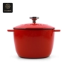 A red, pumpkin-shaped enamel cast iron dutch oven with a lid.