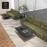 wo green modular sofas with black coffee tables in a contemporary setting.