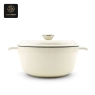 A cream-colored enamel cast iron dutch oven with the lid on, shown from a front view.