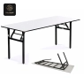 A white rectangular folding banquet table with a black metal frame, set outdoors on concrete.