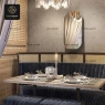 A close-up of a well-appointed dining table within a semi-private booth, with a mirror above.