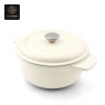 A cream-colored enamel cast iron dutch oven with a lid and 'Success' embossing.